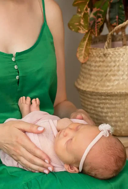 breastfeeding mother holding newborn baby in peaceful setting